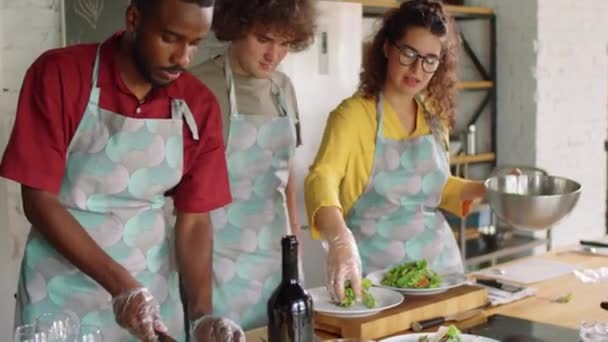 Group Young Multiethnic People Serving Salad Plates Preparing Food Together — Stock Video