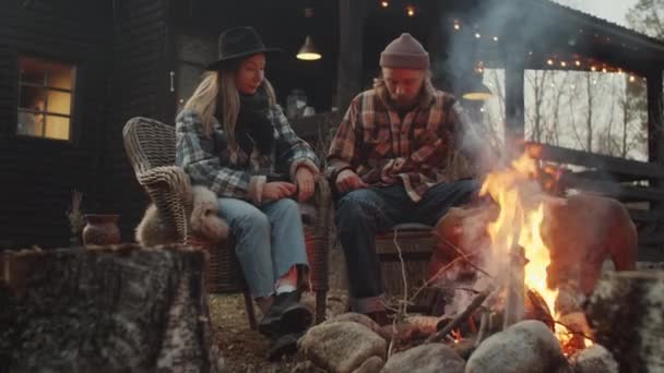 Young Caucasian Couple Petting Pit Bull Dog While Sitting Bonfire — Stock Video