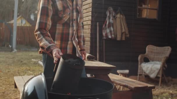 Young Bearded Man Pouring Charcoal Chimney Starter Grill While Preparing — Stock Video