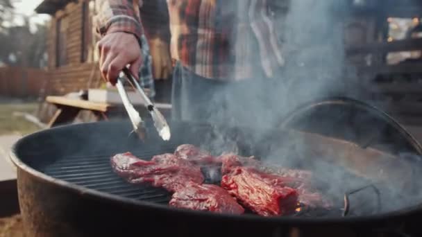 Tilt Shot Caucasian Man Turning Meat Grill Tongues Putting Lid — Stock Video