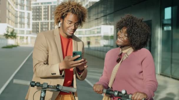 Cheerful Afro American Man Woman Discussing Something Smartphone While Standing — Stock Video
