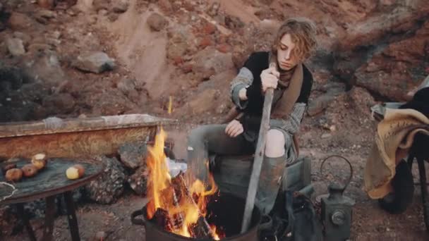 Woman Shabby Clothes Sitting Campsite Dystopian World Warming Hands Fire — Stock Video