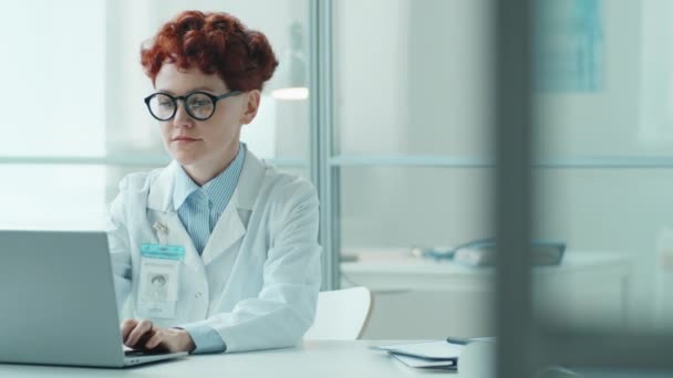 Young Female Doctor Lab Coat Typing Laptop Looking Camera Smiling — Stock Video