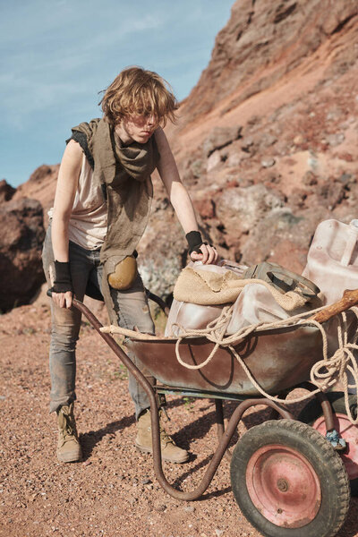 Young woman with cart in the desert
