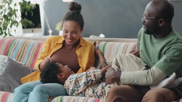 Cheerful Afro American Parents Tickling Laughing Little Son Sofa While — Stock Video