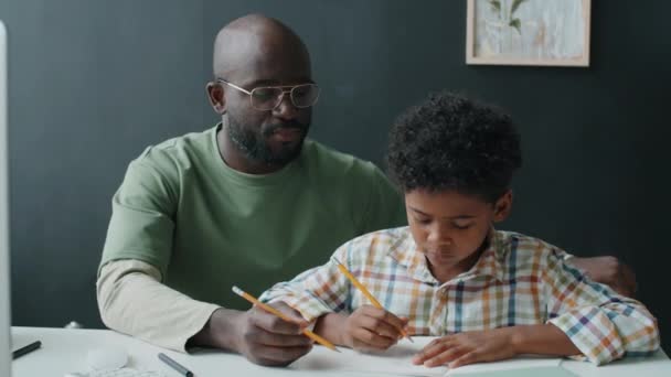 Niño Afroamericano Escribiendo Copybook Viendo Lecciones Línea Computadora Mientras Hace — Vídeos de Stock