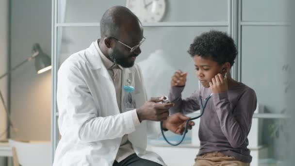 Küçük Afrikalı Amerikalı Çocuk Klinikte Neşeli Bir Doktorla Tıbbi Kanepede — Stok video