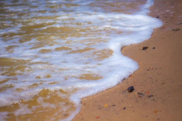 Wave covers sandy beach — Stock Photo, Image