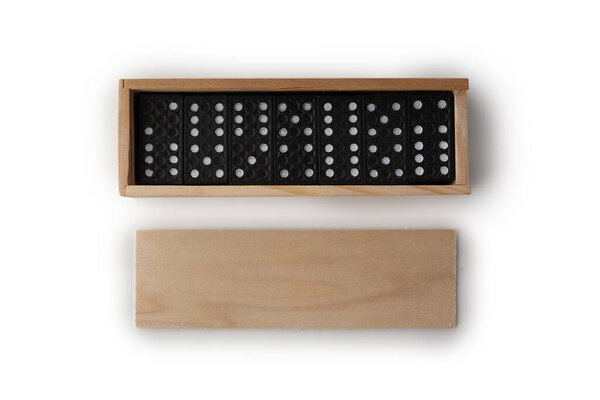 Black dominoes in wooden packaging isolated on white background.