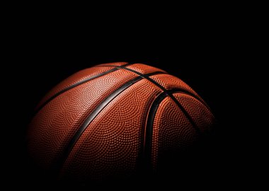 Koyu arkaplanda turuncu renkli güzel bir basketbol topu..