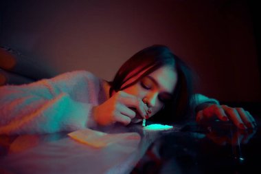 Beyaz kokain tozunu koklayan bir kızın portresi. Bağımlılık ve bağımlılık kavramı.