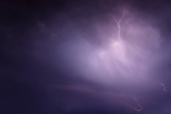 Beautiful natural background with a flash of lightning in dark blue clouds during thunderstorms