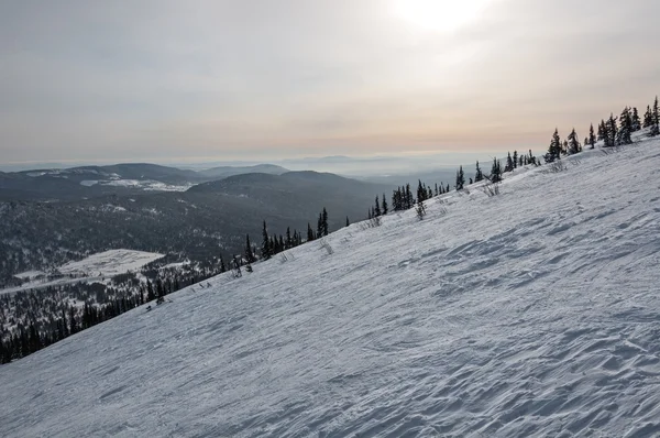 Berg helling sneeuw zonsondergang in de winter — Stockfoto