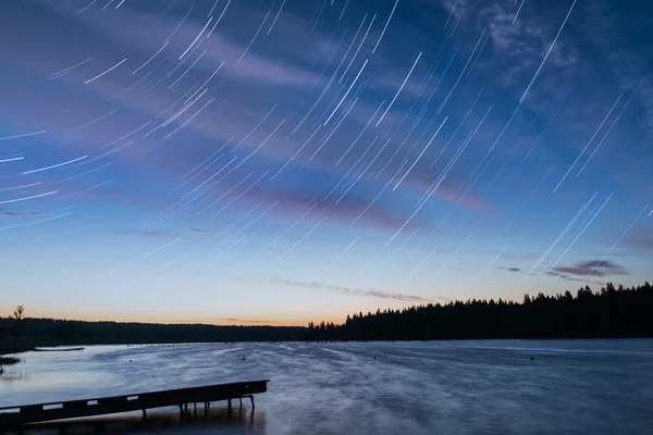 Lake sunset sky clouds tracks — ストック写真