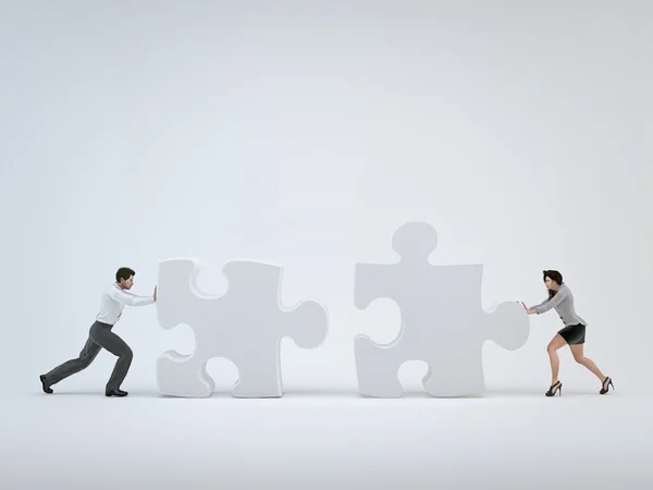 Teamwork, woman and man pushing toward each other puzzle — Stock Photo, Image