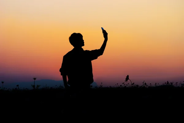 Silhouette of man posing at sunset sky background. — Stock Photo, Image