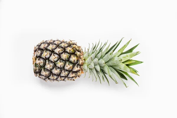 Top view of pineapples on wooden table over white background — Stock Photo, Image