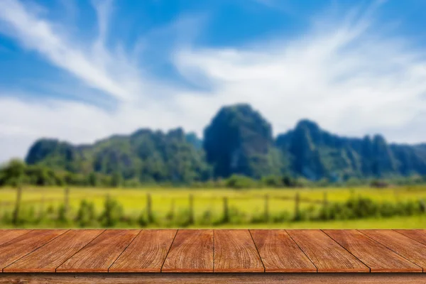 Empty wooden table with mountain landscape — Stock Photo, Image