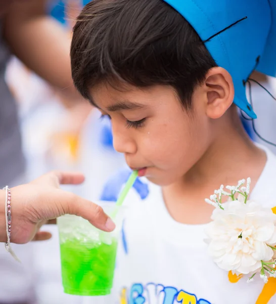 Little boy graduated at kindergarten school drinking water — Stock Photo, Image