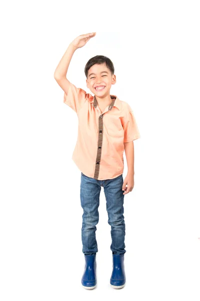 Little boy checking his height on white background — Stock Photo, Image