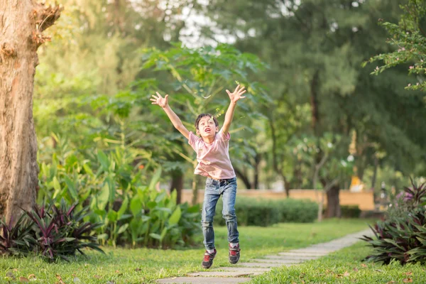 Little boy jumping and running in the park — Stock Photo, Image