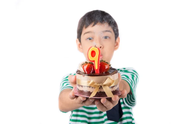 Little boy browing candle on the cake for his birthday — Stock Photo, Image