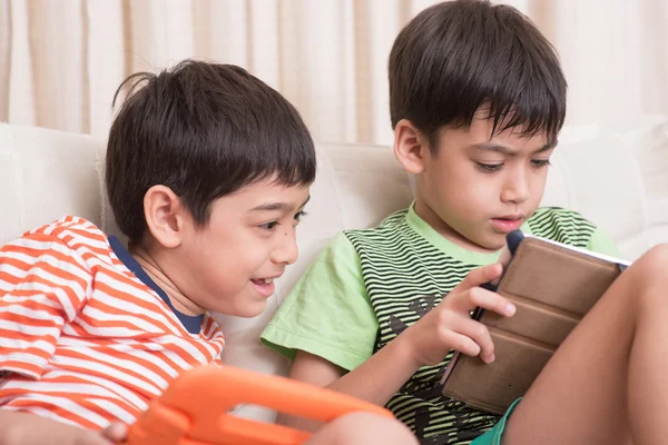 Little sibling boy playing game on mobile tablet with happy together — Stock Photo, Image