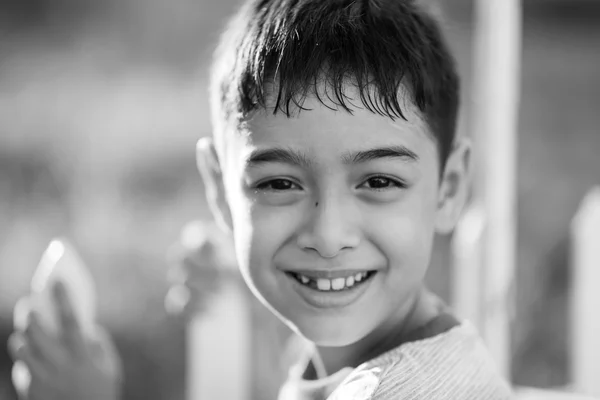 Cerca de la cara feliz del niño al aire libre en el tiempo de puesta del sol en blanco y negro — Foto de Stock