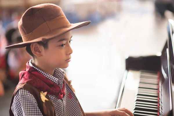 Little boy playing piano outdoor performance — Stock Photo, Image