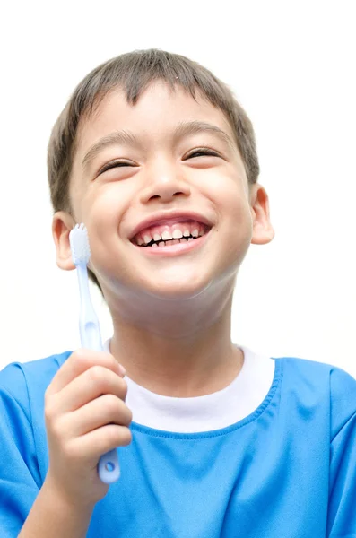 Little Boy escovando os dentes no fundo branco — Fotografia de Stock