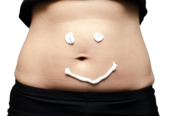 Loción en el estómago de la mujer con sonrisa — Foto de Stock