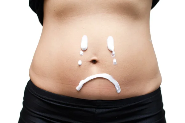 Lotion on woman stomach with crying face — Stock Photo, Image