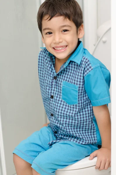 Little boy sitting in toilet — Stock Photo, Image