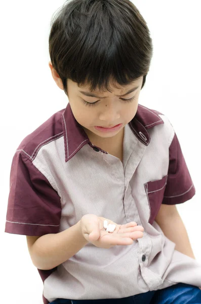 Little boy does'n want to take medicine pill on white background — Stock Photo, Image