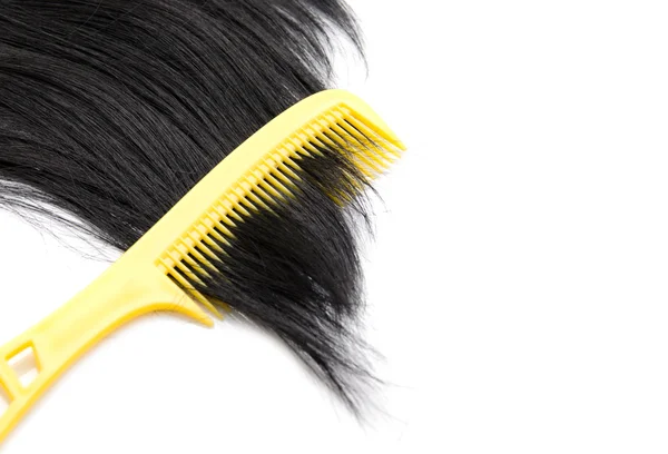 Comb on hair on white background