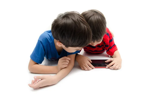 Happy little sibling boy use tablet on white background — Stock Photo, Image