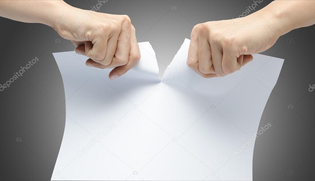 Woman hand ripping white paper on gray background Stock Photo by ©wckiw