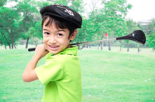 Little boy taking golf club at golf course background Royalty Free Stock Photos