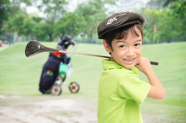Little boy taking golf club on white background Stock Image