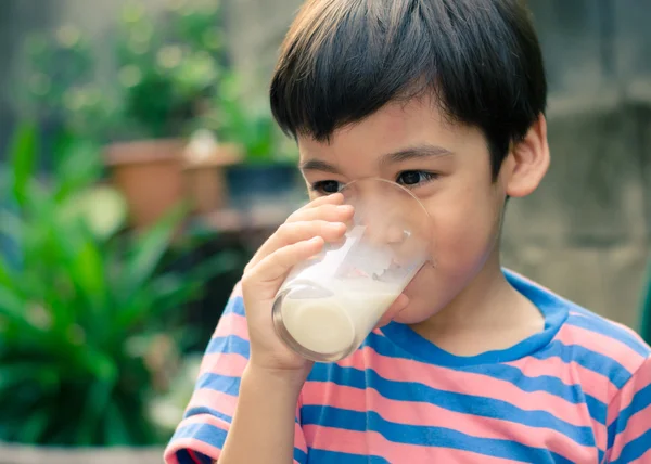 Littl chico bebiendo leche en el parque vintage colo estilo —  Fotos de Stock