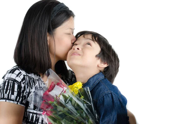 Mother kissong her son with flower on white background — Stock Photo, Image