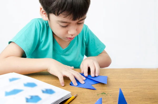 Little boy drawing on paper art origami Stock Picture