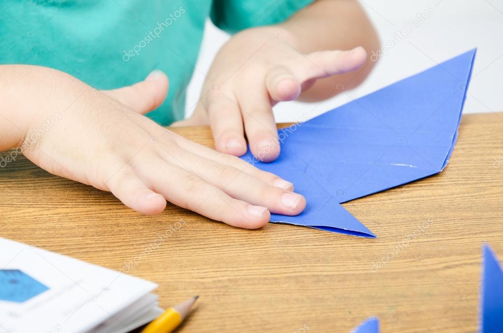 Little boy drawing on paper art origami