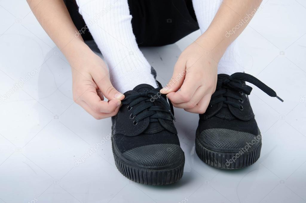 Little boy tie shoes ready for school on white background — Stock Photo