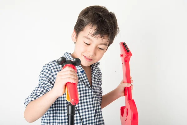 Little boy playing guitar and sing with microphone — Stock Photo, Image