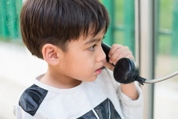 Little boy using public phone outdoor emergency — Stock Photo, Image