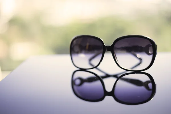 Sun glasses on the table exposure on the beach — Stock Photo, Image