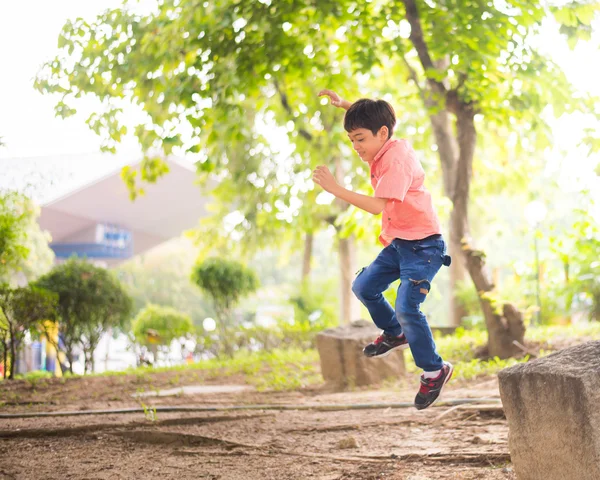 Küçük çocuk parkta atlama — Stok fotoğraf