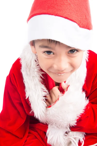 Liten pojke bär jultomten jul rött tyg — Stockfoto