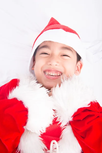 Liten pojke bär jultomten jul rött tyg — Stockfoto